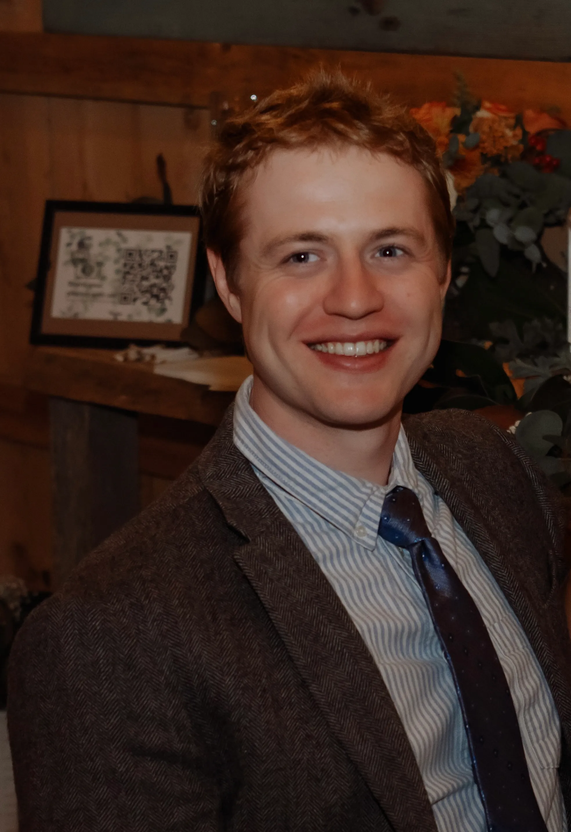 Jacob, smiling in a tweed jacket